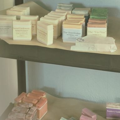 Assorted soaps in various colors and styles displayed on shelves.