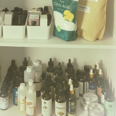Assorted skincare and beauty products on a shelf, including bottles and jars.
